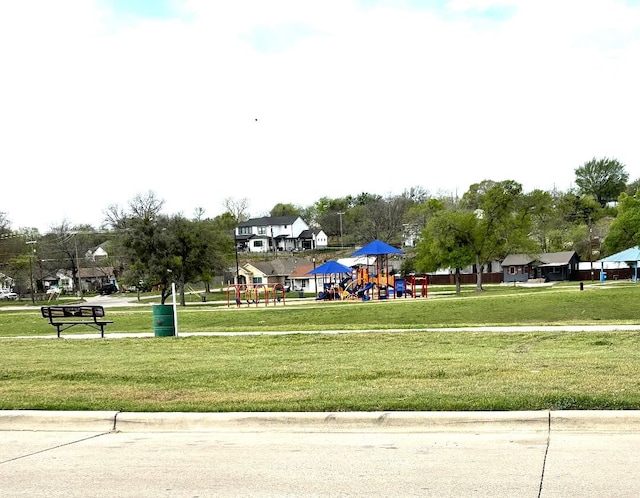 surrounding community featuring a lawn and playground community