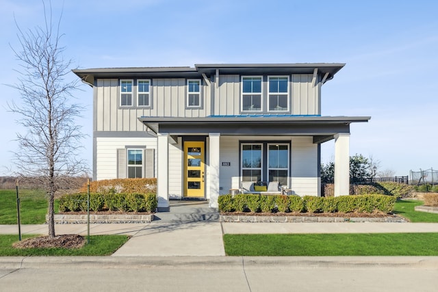 view of front of home featuring covered porch, fence, and board and batten siding