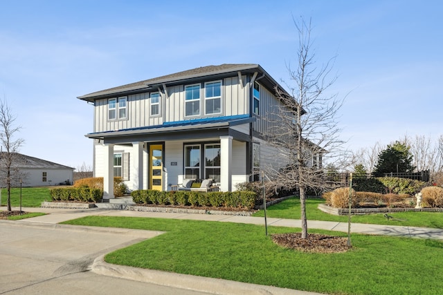 view of front of house featuring board and batten siding, a porch, and a front yard