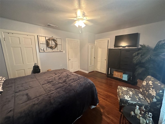 bedroom featuring visible vents, ceiling fan, and dark wood-type flooring