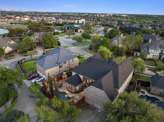 drone / aerial view with a water view and a residential view