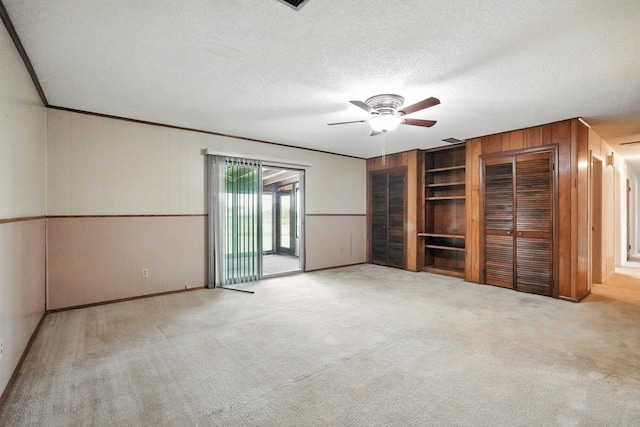2134 Braune Rd, Abilene, TX 79606 - unfurnished bedroom featuring wood walls, access to exterior, crown molding, carpet, and a textured ceiling