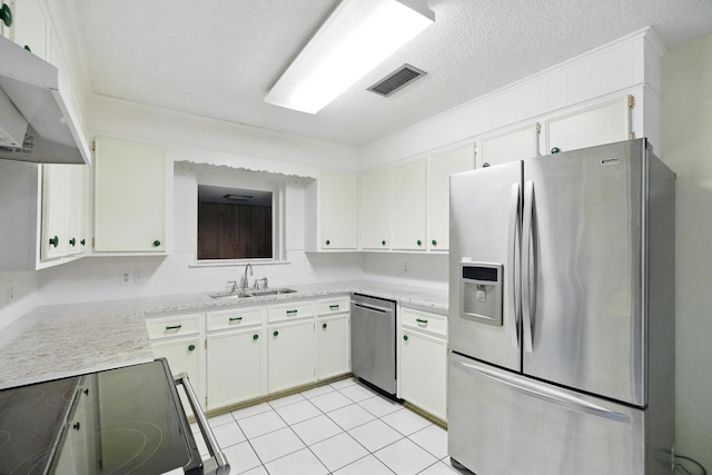 2134 Braune Rd, Abilene, TX 79606 - kitchen featuring stainless steel appliances, a sink, under cabinet range hood, white cabinets, and a textured ceiling