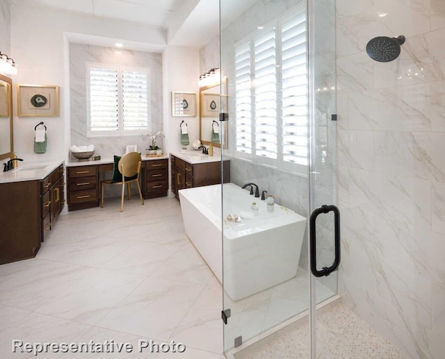 full bathroom with a freestanding bath, a shower stall, two vanities, and a sink