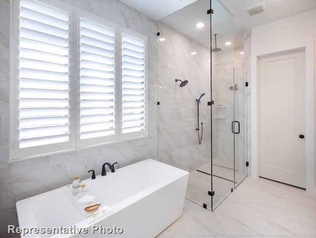 bathroom with visible vents, a marble finish shower, recessed lighting, a freestanding tub, and marble finish floor