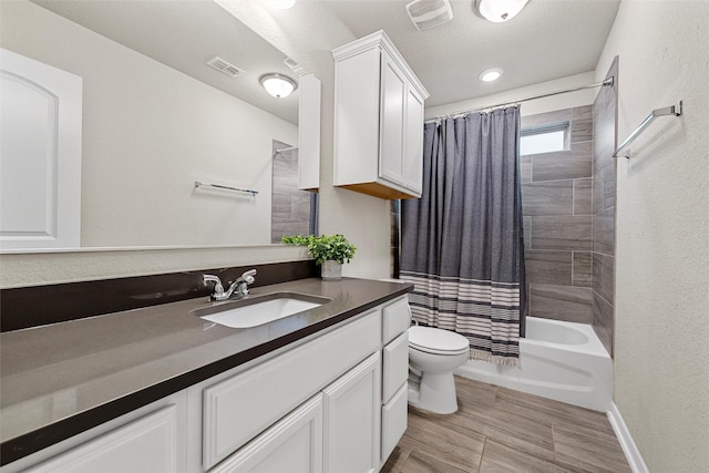full bathroom featuring visible vents, vanity, toilet, baseboards, and shower / bathtub combination with curtain