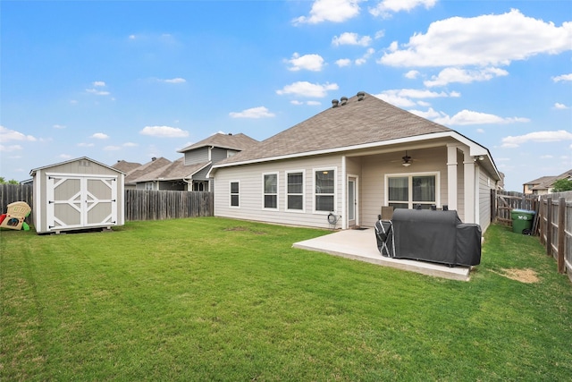 back of house with a fenced backyard, a ceiling fan, a patio area, and a shed