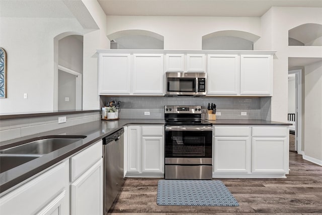 kitchen with white cabinetry, tasteful backsplash, and stainless steel appliances