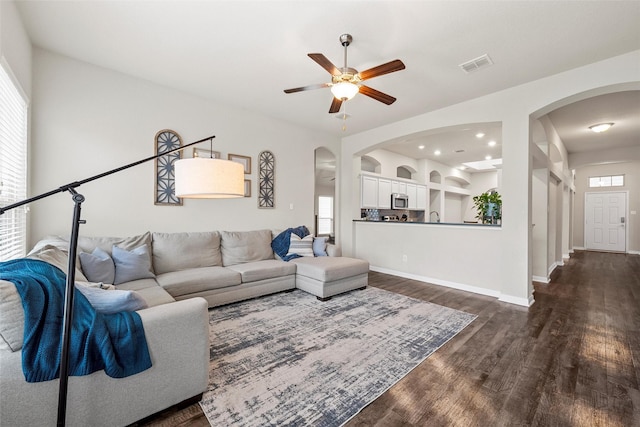 3017 Gilchrist Dr, Waco, TX 76655 - living room featuring arched walkways, dark wood-style flooring, visible vents, and a ceiling fan