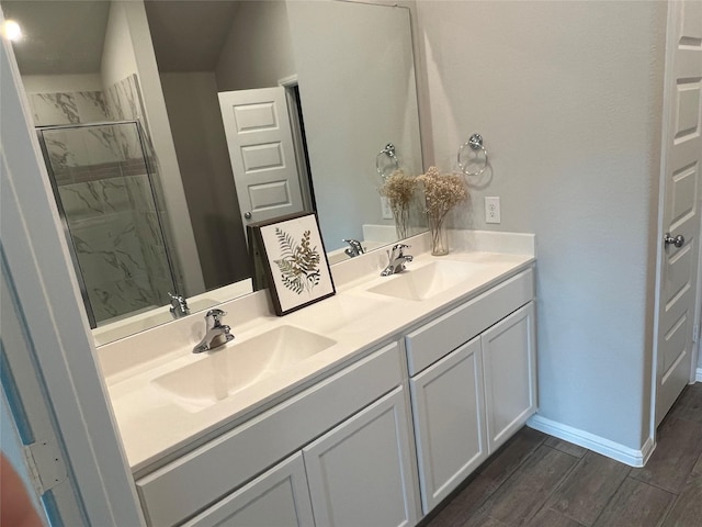 13165 Yellowstone Way, Providence Village, TX 76227 - full bath with double vanity, a stall shower, wood finished floors, and baseboards