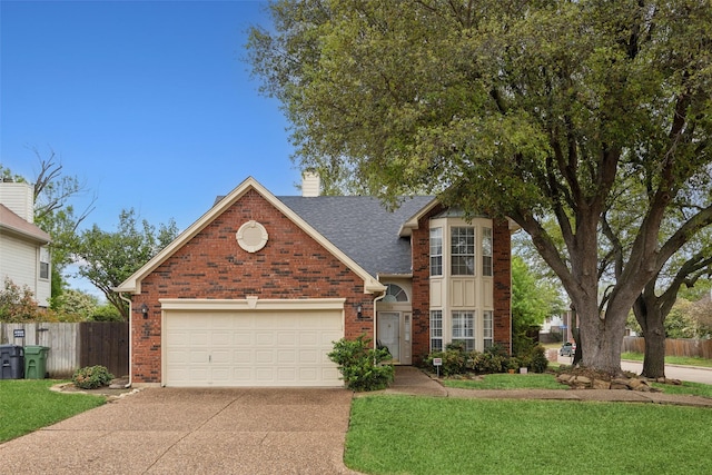 traditional-style house featuring fence, a chimney, concrete driveway, and brick siding