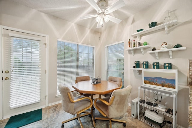 dining space with a textured ceiling and a ceiling fan
