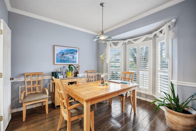 dining space with crown molding, a textured ceiling, baseboards, and dark wood finished floors