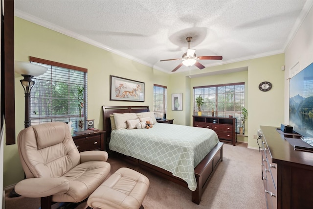carpeted bedroom featuring crown molding, a textured ceiling, and a ceiling fan