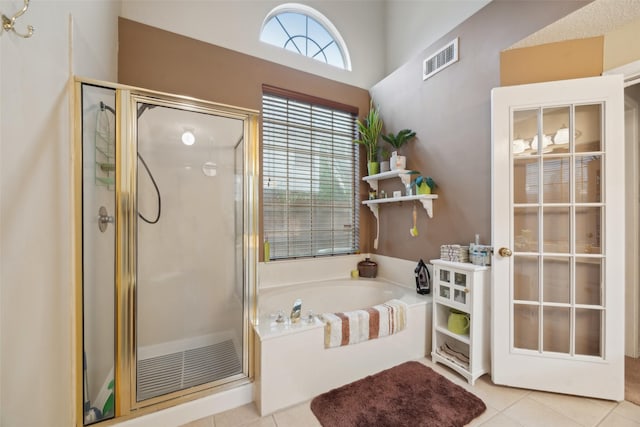 bathroom with visible vents, a stall shower, a garden tub, and tile patterned flooring