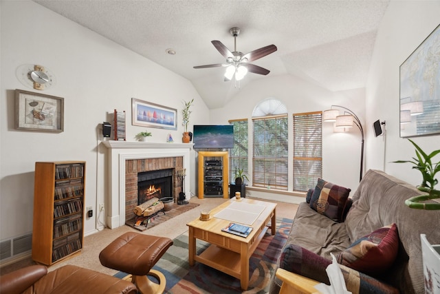 carpeted living area featuring a brick fireplace, ceiling fan, vaulted ceiling, baseboards, and a textured ceiling