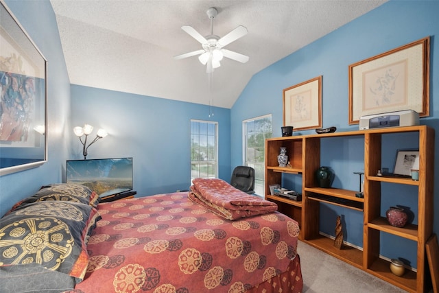 bedroom featuring a textured ceiling, ceiling fan, vaulted ceiling, and carpet floors