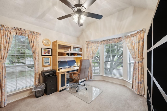 carpeted home office with ceiling fan, lofted ceiling, and baseboards