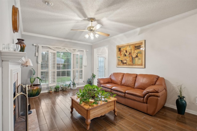 living room with a textured ceiling, ceiling fan, and wood finished floors