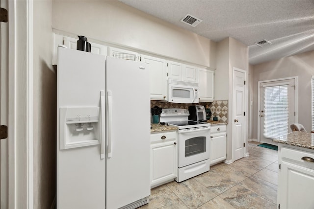 kitchen with visible vents, white cabinets, tasteful backsplash, and white appliances