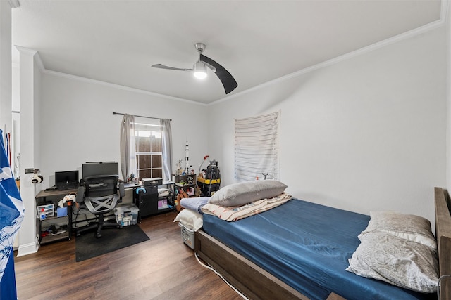 bedroom with wood finished floors, crown molding, and a ceiling fan