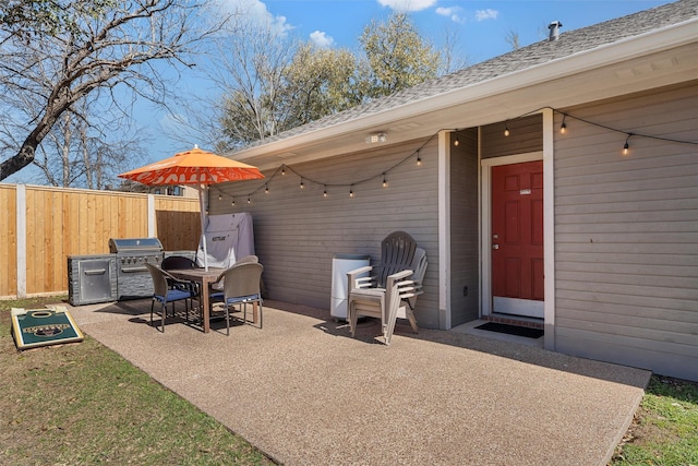 view of patio / terrace featuring a grill and fence