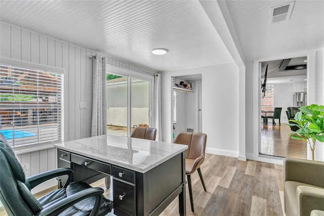 home office with baseboards, visible vents, and light wood-style floors