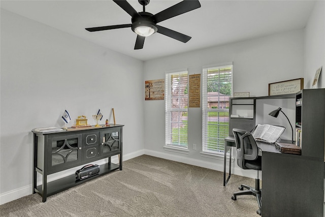 office featuring baseboards, ceiling fan, and carpet flooring