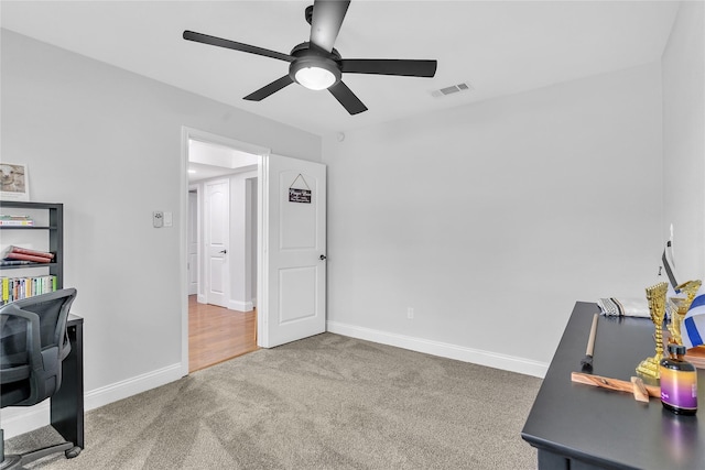 office area with visible vents, ceiling fan, baseboards, and carpet floors