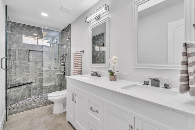 full bath featuring toilet, a shower stall, and a sink