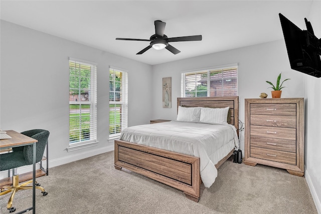 carpeted bedroom with a ceiling fan and baseboards