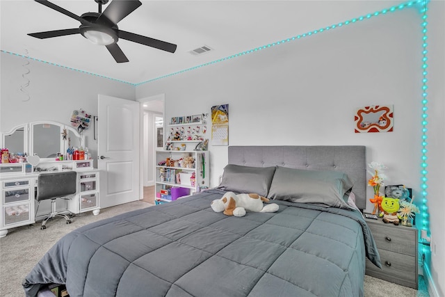 bedroom with carpet, visible vents, and a ceiling fan