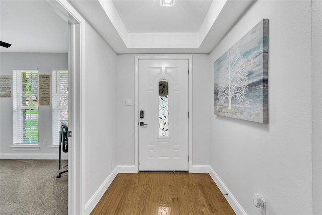 foyer with wood finished floors and baseboards