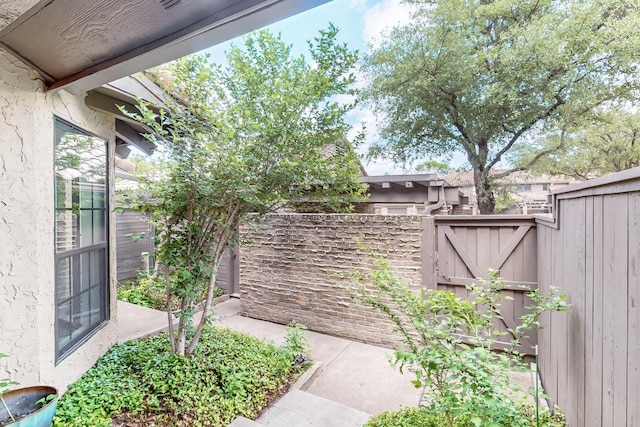 view of yard featuring fence and a gate