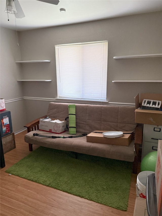 living room featuring wood finished floors and ceiling fan