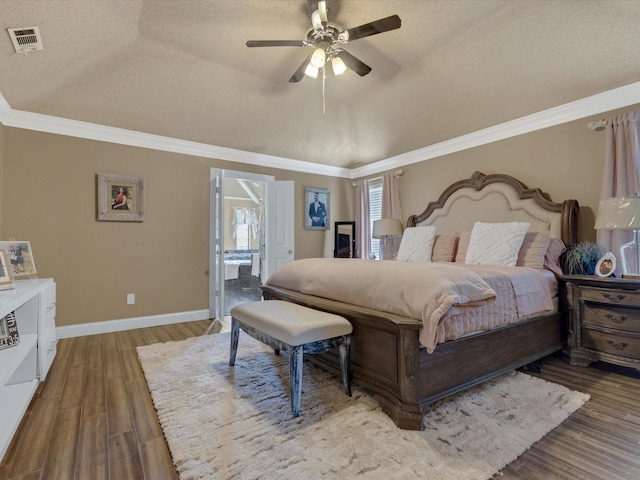 bedroom featuring baseboards, visible vents, ornamental molding, and wood finished floors