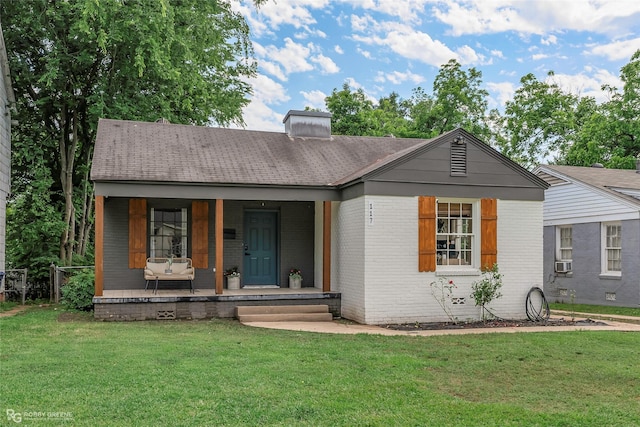 single story home with brick siding, a front yard, and a chimney