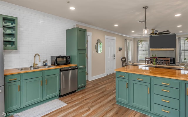 kitchen with butcher block countertops, dishwasher, a sink, black microwave, and ceiling fan