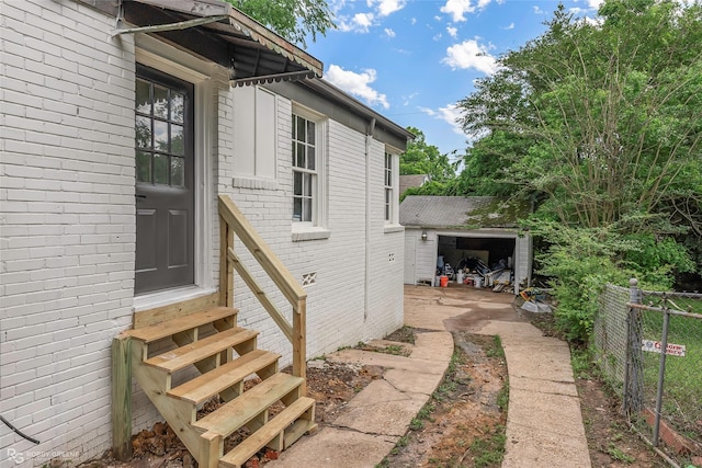 entrance to property with fence and brick siding