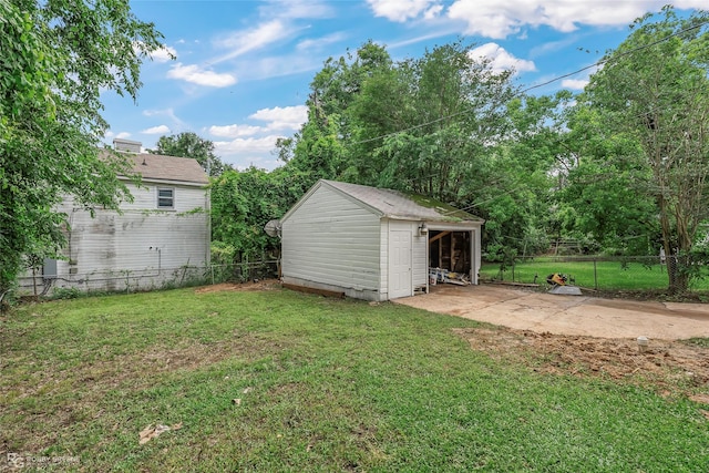 view of yard featuring a patio area, an outbuilding, and a storage unit