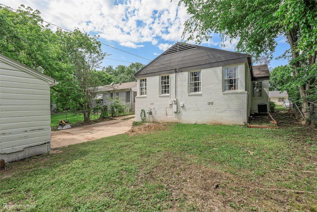 back of house featuring brick siding and cooling unit
