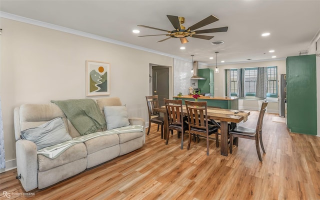 dining area featuring ornamental molding, light wood-style floors, ceiling fan, and recessed lighting
