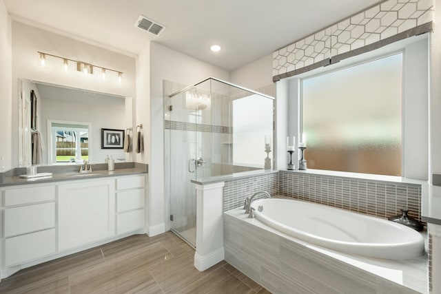 1009 Canuela Way, Justin, TX 76247 - bathroom featuring visible vents, a shower stall, a bath, and vanity