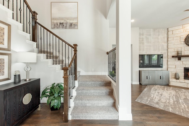 1009 Canuela Way, Justin, TX 76247 - staircase featuring baseboards, wood finished floors, and a fireplace