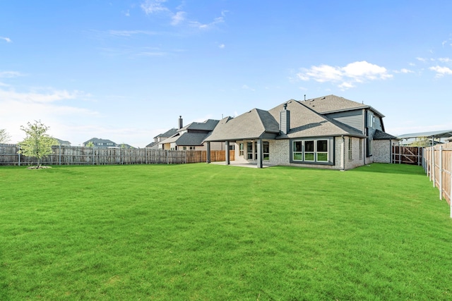 1009 Canuela Way, Justin, TX 76247 - back of property with a fenced backyard, brick siding, a shingled roof, a patio, and a lawn