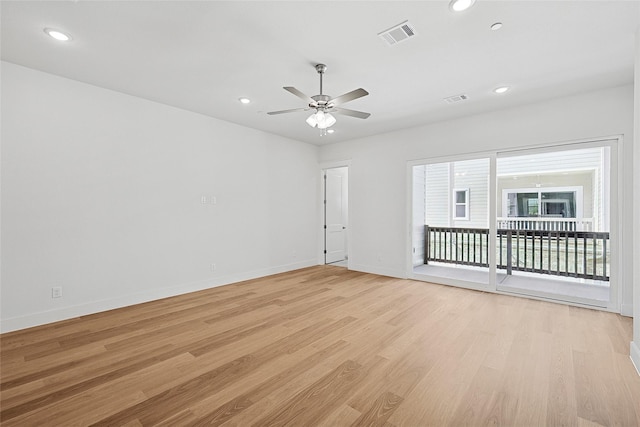 empty room featuring visible vents, light wood-style flooring, and recessed lighting