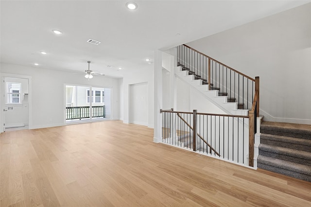 unfurnished living room with visible vents, a wealth of natural light, and light wood-style flooring