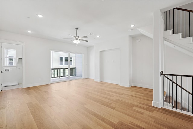 unfurnished living room with ceiling fan, light wood-style flooring, and plenty of natural light