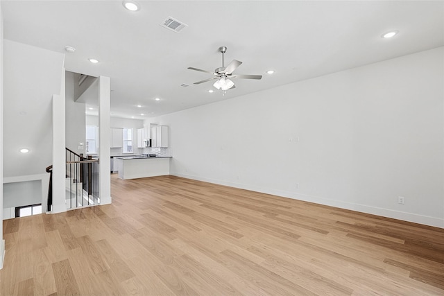 unfurnished living room featuring visible vents, a ceiling fan, light wood-style flooring, and recessed lighting