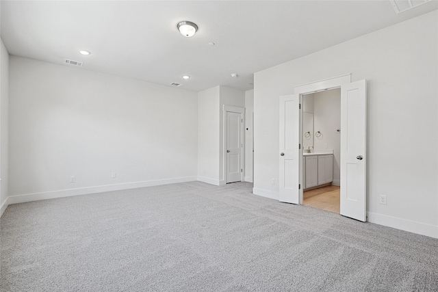 unfurnished bedroom with recessed lighting, visible vents, light colored carpet, and baseboards